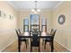 Dining room with hardwood floors, natural light, a dark wood table and chairs, and neutral walls at 2717 Via Cipriani # 620A, Clearwater, FL 33764