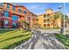 Stunning condo building featuring manicured lawns and brick paver walkways on a sunny day at 2717 Via Cipriani # 620A, Clearwater, FL 33764
