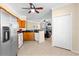 Bright kitchen with stainless steel appliances, wood cabinets, and a breakfast bar open to the living room at 2717 Via Cipriani # 620A, Clearwater, FL 33764