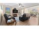 Inviting living room with a fireplace, comfortable seating, hardwood floors, and ample natural light at 2717 Via Cipriani # 620A, Clearwater, FL 33764
