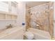 Well-appointed bathroom with modern fixtures, tiled walls, and a shower-tub combination for a spa-like experience at 3302 W Van Buren Dr, Tampa, FL 33611