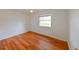 Light-filled bedroom features a window and wood-look flooring at 3302 W Van Buren Dr, Tampa, FL 33611