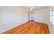 Bright bedroom features wood-look flooring, closet, and a ceiling fan at 3302 W Van Buren Dr, Tampa, FL 33611