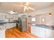 Bright kitchen with stainless steel appliances, white cabinetry, and wood flooring, creating a modern and functional space at 3302 W Van Buren Dr, Tampa, FL 33611