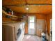 Indoor laundry room featuring a washer, dryer, and storage solutions at 3302 W Van Buren Dr, Tampa, FL 33611