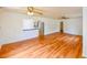 Open-concept living room with hardwood floors, ample space, and easy access to the kitchen and other living areas at 3302 W Van Buren Dr, Tampa, FL 33611