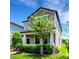 Charming two-story home with well-manicured lawn, mature trees, and inviting covered front porch at 3568 Pine Ribbon Dr, Land O Lakes, FL 34638
