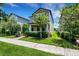 Beautiful home exterior with lush green lawn, landscaped shrubbery, and a charming sidewalk at 3568 Pine Ribbon Dr, Land O Lakes, FL 34638