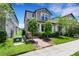Inviting two-story home with brick walkway, lush landscaping, and manicured front yard at 3568 Pine Ribbon Dr, Land O Lakes, FL 34638