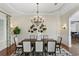 Elegant dining room with decorative chandelier, wainscoting and dark wood flooring at 416 Shore E Dr, Oldsmar, FL 34677