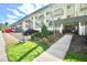 Condo exterior featuring manicured landscaping, covered parking, and private balconies at 4610 W Gray St # 208, Tampa, FL 33609