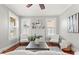 Cozy living room with a decorative fireplace, stylish decor, hardwood floors, and a ceiling fan at 5807 N Branch Ave, Tampa, FL 33604