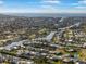 Expansive aerial view of a waterfront community featuring beautiful homes and a scenic canal leading to the ocean at 6411 Grenada Island Ave, Apollo Beach, FL 33572