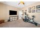Bedroom featuring exercise equipment, TV, and stylish decor on neutral walls at 6411 Grenada Island Ave, Apollo Beach, FL 33572