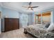 Comfortable primary bedroom with a large window and access to the outdoor patio at 6411 Grenada Island Ave, Apollo Beach, FL 33572