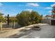 Sandy backyard with a brick fire pit, foliage, and views of the canal and neighboring homes at 6411 Grenada Island Ave, Apollo Beach, FL 33572