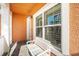 Cozy front porch with a white bench and large window providing natural light and a comfortable seating area at 6411 Grenada Island Ave, Apollo Beach, FL 33572