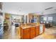 Open-concept kitchen with a center island, dining area, sliding doors to a patio, and view of an adjacent billiards room at 6411 Grenada Island Ave, Apollo Beach, FL 33572