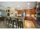 Updated kitchen with a breakfast bar, wooden cabinetry, stainless steel refrigerator, and modern appliances at 6411 Grenada Island Ave, Apollo Beach, FL 33572