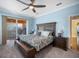 This main bedroom features a ceiling fan, balcony access, and a seating area at 6411 Grenada Island Ave, Apollo Beach, FL 33572