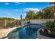 This home has an outdoor swimming pool and lounge seating area with an umbrella at 6411 Grenada Island Ave, Apollo Beach, FL 33572