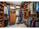 Spacious walk-in closet with custom shelving and drawers for organization at 6411 Grenada Island Ave, Apollo Beach, FL 33572