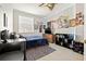 Cozy bedroom with posters, blue bedding, wood floors, and a ceiling fan at 6980 Ulmerton Rd # 8C, Largo, FL 33771