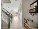 Inviting hallway with stairs, bench, and decor, leading to the open living space at 6980 Ulmerton Rd # 8C, Largo, FL 33771