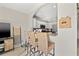 Breakfast bar open to kitchen featuring white cabinets, granite countertops, and stainless steel appliances at 6980 Ulmerton Rd # 8C, Largo, FL 33771