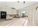 The open living room features large sliding glass doors, a modern ceiling fan, and neutral paint at 6980 Ulmerton Rd # 8C, Largo, FL 33771