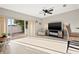 Bright living room featuring large sliding glass doors to the yard, ceiling fan, and modern decor at 6980 Ulmerton Rd # 8C, Largo, FL 33771