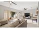 Open concept living room with sliding glass doors to the outdoor patio and modern ceiling fans at 6980 Ulmerton Rd # 8C, Largo, FL 33771