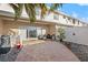Outdoor patio area with stone pavers, privacy fence, sliding glass door, and tropical landscaping at 6980 Ulmerton Rd # 8C, Largo, FL 33771