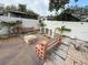 Backyard with built-in benches, a built-in fire pit and stone tile at 8503 N Willow Ave, Tampa, FL 33604