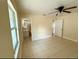 Bedroom featuring neutral walls, ceiling fan, and easy access to a bathroom and a closet at 8503 N Willow Ave, Tampa, FL 33604