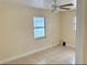 Neutral toned bedroom with tile flooring and a ceiling fan at 8503 N Willow Ave, Tampa, FL 33604