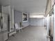 Spacious covered parking area with concrete flooring and access to the entrance and storage at 8503 N Willow Ave, Tampa, FL 33604