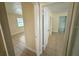 Hallway showcasing tile floors and access to multiple rooms, with neutral wall paint at 8503 N Willow Ave, Tampa, FL 33604