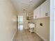 Bright laundry room with a utility sink, storage cabinets, and washer/dryer hookups at 8503 N Willow Ave, Tampa, FL 33604