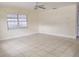 Bright, spacious living room featuring neutral walls, tile flooring, and a ceiling fan at 8503 N Willow Ave, Tampa, FL 33604