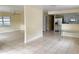 Spacious living area featuring tile flooring, and stainless steel appliances in the kitchen at 8503 N Willow Ave, Tampa, FL 33604