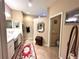 Well-lit bathroom with double sinks, decorative mirrors, and tile flooring at 116 Silver Falls Dr, Apollo Beach, FL 33572