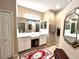 Bathroom featuring double sink vanity, large mirrors, and neutral tile at 116 Silver Falls Dr, Apollo Beach, FL 33572