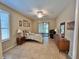 Cozy bedroom with tiled flooring, neutral colors and sliding glass doors leading to the outdoors at 116 Silver Falls Dr, Apollo Beach, FL 33572
