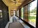 Enclosed lanai with ceiling fans and views of the well-maintained backyard at 116 Silver Falls Dr, Apollo Beach, FL 33572