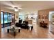 Open concept living room boasts tile flooring, modern furniture, and seamless access to the kitchen and lanai at 116 Silver Falls Dr, Apollo Beach, FL 33572