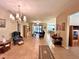 Spacious living room features tile flooring, chandelier, and seamlessly connects to the dining and kitchen areas at 116 Silver Falls Dr, Apollo Beach, FL 33572
