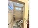 Step-in shower with decorative tile border and convenient grab bars at 116 Silver Falls Dr, Apollo Beach, FL 33572
