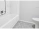 Clean bathroom with a tub and stylish patterned tile flooring at 1227 Queen Anne Dr # C, Palm Harbor, FL 34684