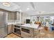 Modern kitchen featuring stainless steel appliances and a breakfast bar overlooking the living area at 1227 Queen Anne Dr # C, Palm Harbor, FL 34684